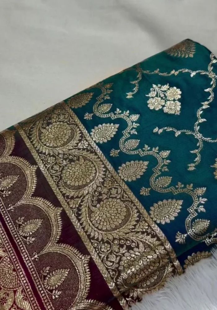 Teal fabric with intricate gold embroidery